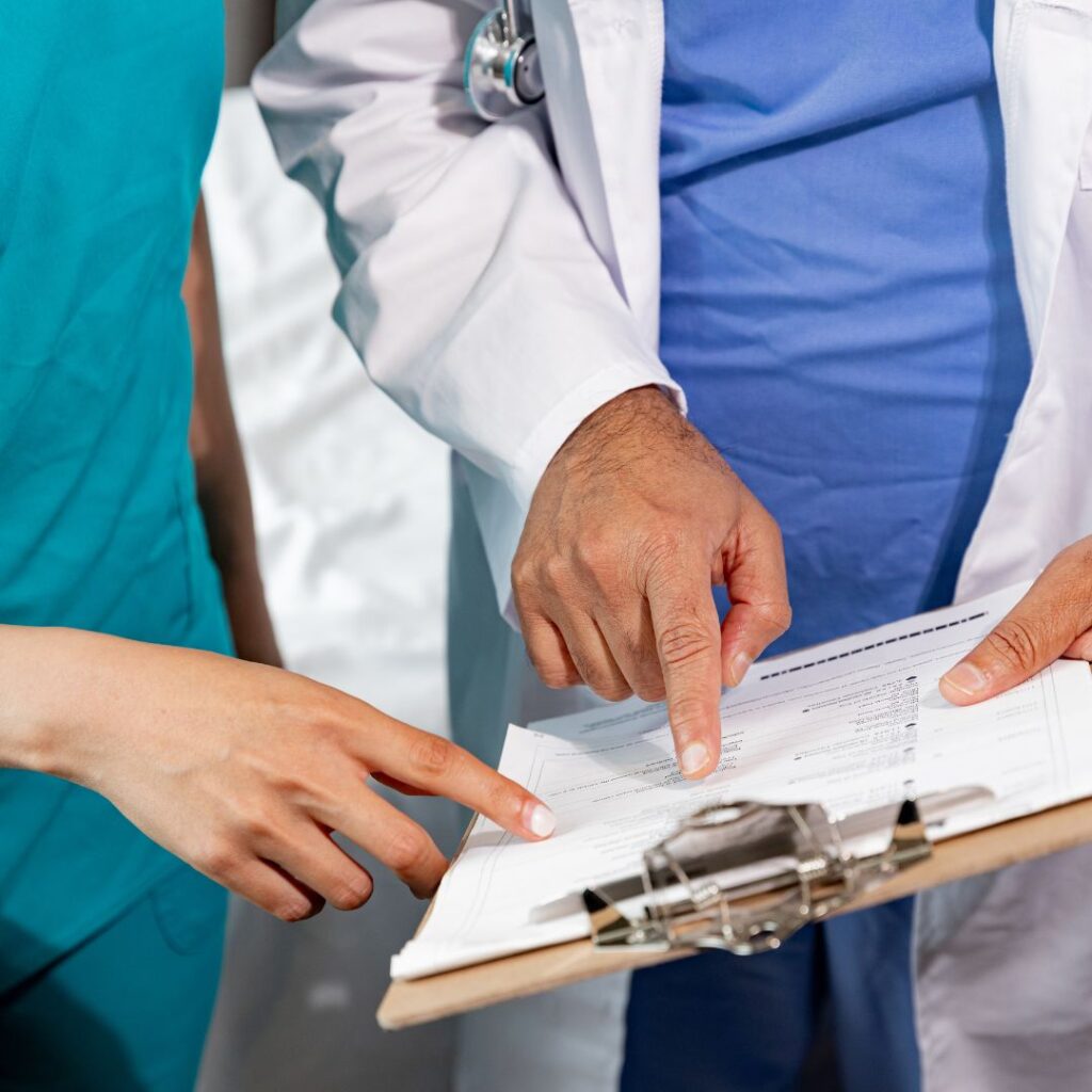 doctor and nurse pointing at papers
