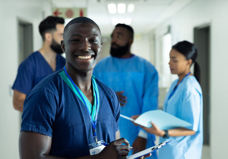 Portrait of smiling african american male healthcare worker writ